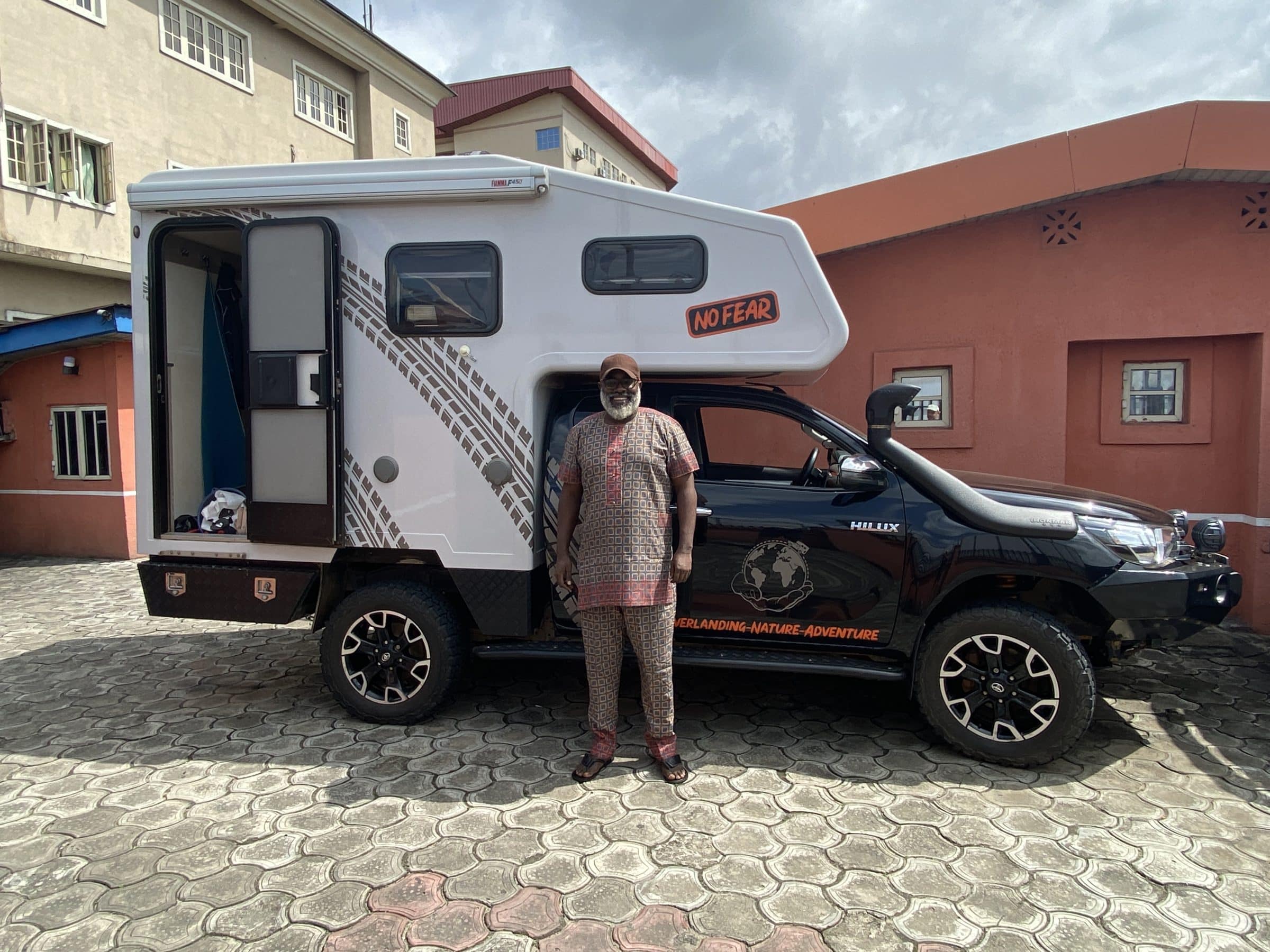 Okiki, the hotel owner in the picture with our Overlander